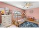 Adorable pink bedroom featuring a unique toddler bed frame and beautiful decor at 934 W Heron Cir, Winter Haven, FL 33884