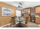 A dining room with a glass table, wicker chairs, wood floors, and coastal decor near the kitchen at 934 W Heron Cir, Winter Haven, FL 33884