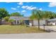 Charming single-story home featuring a well-manicured lawn, lush landscaping, and an attached two-car garage at 934 W Heron Cir, Winter Haven, FL 33884