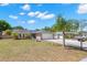 Charming single-story home with a well-manicured lawn, mature landscaping, and an extended driveway leading to a two-car garage at 934 W Heron Cir, Winter Haven, FL 33884