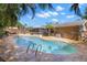 Private backyard oasis featuring a kidney-shaped pool and patio at 934 W Heron Cir, Winter Haven, FL 33884