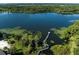Aerial view of lake featuring a pier with seating area, surrounded by lush trees at 3337 Soho St # 103, Orlando, FL 32835