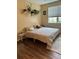 Bedroom featuring natural light, hardwood floors, and minimalist decor at 3337 Soho St # 103, Orlando, FL 32835