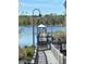 Dock with a covered gazebo and lights overlooking a peaceful lake at 3301 Soho St # 102, Orlando, FL 32835