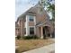 Charming two-story home featuring an arched entrance and freshly landscaped front yard at 3337 Soho St # 103, Orlando, FL 32835