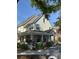Charming two-story townhome featuring a welcoming covered front porch and landscaped surroundings at 3324 Parkchester Square Blvd # 102, Orlando, FL 32835