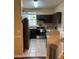 Kitchen with stainless steel appliances, dark cabinets and a breakfast bar area at 3337 Soho St # 103, Orlando, FL 32835