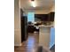 Modern kitchen with stainless steel appliances, dark wood cabinets, and granite countertops at 3301 Soho St # 102, Orlando, FL 32835