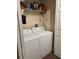 Practical laundry area featuring a washer, dryer, and shelving for storage at 3324 Parkchester Square Blvd # 102, Orlando, FL 32835