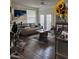 Comfortable living room with wood floors, a beige couch, and natural light from the doors at 3324 Parkchester Square Blvd # 102, Orlando, FL 32835