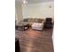 Comfortable living room featuring a plush couch, ottoman, recliner, and wood-look flooring at 3301 Soho St # 102, Orlando, FL 32835