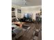 Cozy living room features wood floors, a modern entertainment center, and ample natural light at 3324 Parkchester Square Blvd # 102, Orlando, FL 32835