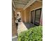 Comfortable covered patio with tiled floor and large glass doors to the interior at 3301 Soho St # 102, Orlando, FL 32835