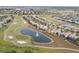 Aerial view shows the neighborhood, golf course, lake and surrounding homes at 1568 Maidstone Ct, Davenport, FL 33896