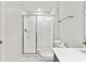Modern bathroom with white tile shower and bright vanity at 1568 Maidstone Ct, Davenport, FL 33896
