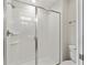 Modern bathroom shower with white tile and glass door at 1568 Maidstone Ct, Davenport, FL 33896
