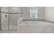 Elegant bathroom featuring a walk-in shower, soaking tub, and marble tile at 1568 Maidstone Ct, Davenport, FL 33896