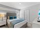 Bedroom with queen bed, modern decor, and ample natural light at 1568 Maidstone Ct, Davenport, FL 33896