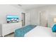Bedroom featuring a bed and dresser with wall-mounted tv at 1568 Maidstone Ct, Davenport, FL 33896