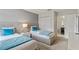 Bright bedroom featuring twin beds, neutral walls, closet and bathroom access at 1568 Maidstone Ct, Davenport, FL 33896