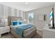 Bedroom with queen bed, modern decor, and ample natural light at 1568 Maidstone Ct, Davenport, FL 33896