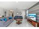Comfortable living room with tile floors, gray couches, and stylish decor at 1568 Maidstone Ct, Davenport, FL 33896