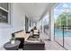 Cozy covered patio with comfortable seating and a view of the pool at 1568 Maidstone Ct, Davenport, FL 33896