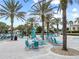 The inviting pool area has lounge chairs, tables and shady palm trees to relax under at 1568 Maidstone Ct, Davenport, FL 33896