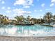 Beautiful pool with lounge chairs, palm trees, and slides, perfect for relaxation at 1568 Maidstone Ct, Davenport, FL 33896
