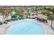 A large community pool features a bar and ample seating, surrounded by lush landscaping at 1568 Maidstone Ct, Davenport, FL 33896