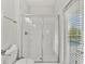 Bathroom featuring shower with glass door and partially-view of pool area at 1568 Maidstone Ct, Davenport, FL 33896