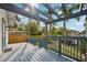 The back deck features a light blue pergola with a blue rail overlooking a grassy area at 515 Frank Lloyd Wright Way, Lakeland, FL 33803