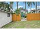 Backyard with a new wooden fence and a blue door visible on the home at 515 Frank Lloyd Wright Way, Lakeland, FL 33803