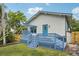 This home has a light blue back deck with a small pergola and a blue back door at 515 Frank Lloyd Wright Way, Lakeland, FL 33803