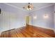 Bedroom with hardwood floors, two wall sconces, and a ceiling fan at 515 Frank Lloyd Wright Way, Lakeland, FL 33803