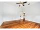 Spacious bedroom with ceiling fan, hardwood flooring, and an open door at 515 Frank Lloyd Wright Way, Lakeland, FL 33803