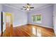 Bedroom with hardwood floors, ceiling fan, and view from window at 515 Frank Lloyd Wright Way, Lakeland, FL 33803