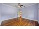 Bedroom with hardwood floors, ceiling fan, and natural light at 515 Frank Lloyd Wright Way, Lakeland, FL 33803
