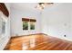 Large bedroom with ceiling fan, polished wood floors, and two windows at 515 Frank Lloyd Wright Way, Lakeland, FL 33803
