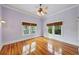 Bedroom featuring hardwood floors, two windows, and a ceiling fan at 515 Frank Lloyd Wright Way, Lakeland, FL 33803