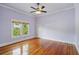 Bedroom with hardwood floors, a ceiling fan, and a view from the window at 515 Frank Lloyd Wright Way, Lakeland, FL 33803