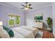 Serene bedroom with soft lavender walls, hardwood floors, and ample natural light at 515 Frank Lloyd Wright Way, Lakeland, FL 33803