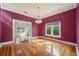 Elegant dining area with hardwood floors and a view into the entry at 515 Frank Lloyd Wright Way, Lakeland, FL 33803