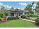 Well-maintained home featuring a wide front lawn and inviting covered porch at 515 Frank Lloyd Wright Way, Lakeland, FL 33803