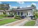 Inviting single-story house with a classic front porch and tidy landscaping at 515 Frank Lloyd Wright Way, Lakeland, FL 33803