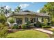 Inviting single-story home with well-kept landscaping and a cozy covered porch at 515 Frank Lloyd Wright Way, Lakeland, FL 33803