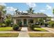 Charming home with a welcoming front porch, beautiful landscaping, and a well-maintained lawn at 515 Frank Lloyd Wright Way, Lakeland, FL 33803