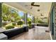 Wide front porch showcasing detailed tile, ceiling fans, and a charming outdoor space at 515 Frank Lloyd Wright Way, Lakeland, FL 33803