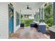 Spacious covered porch with classic columns and detailed tile flooring at 515 Frank Lloyd Wright Way, Lakeland, FL 33803