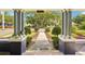 View from a covered porch, showing an inviting walkway and manicured greenery at 515 Frank Lloyd Wright Way, Lakeland, FL 33803